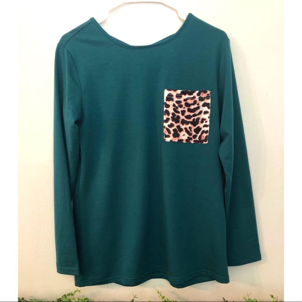 Teal/green long sleeve with leopard pocket and a criss-cross upper back.